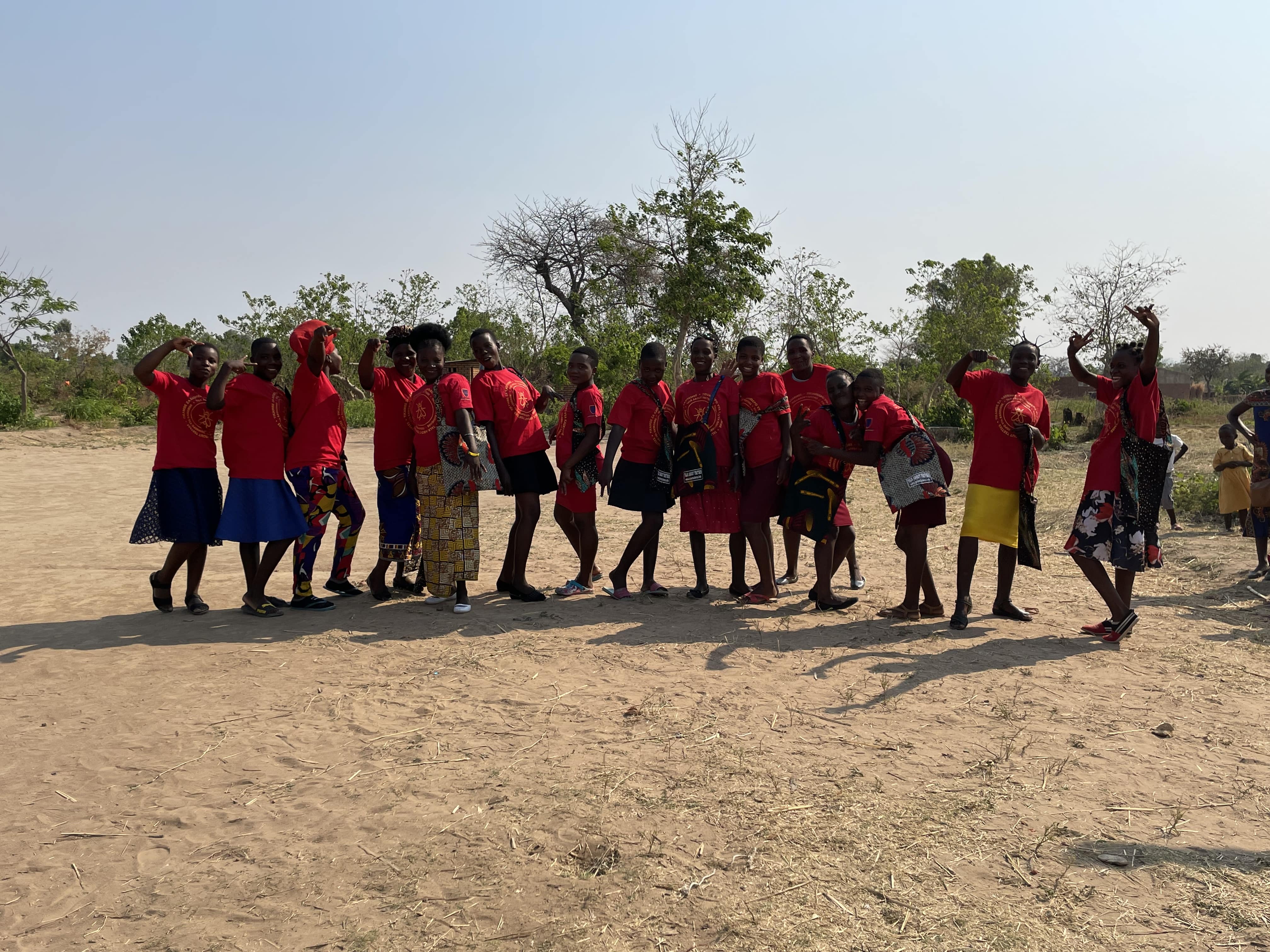 A group of Ladies shows off their Beautiful red Tsetse tshirts and Tsetse Bags